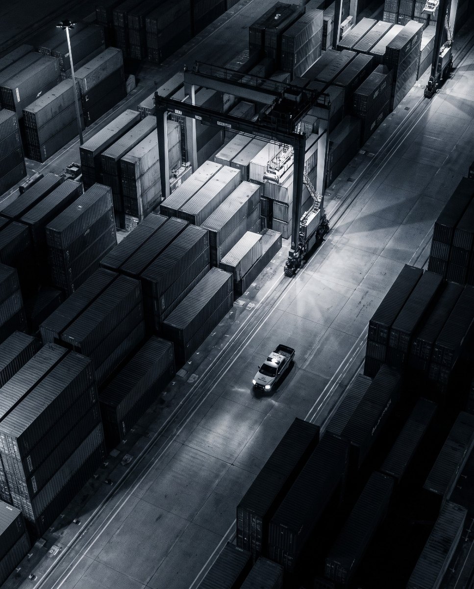 Container port at night with a patrol vehicle