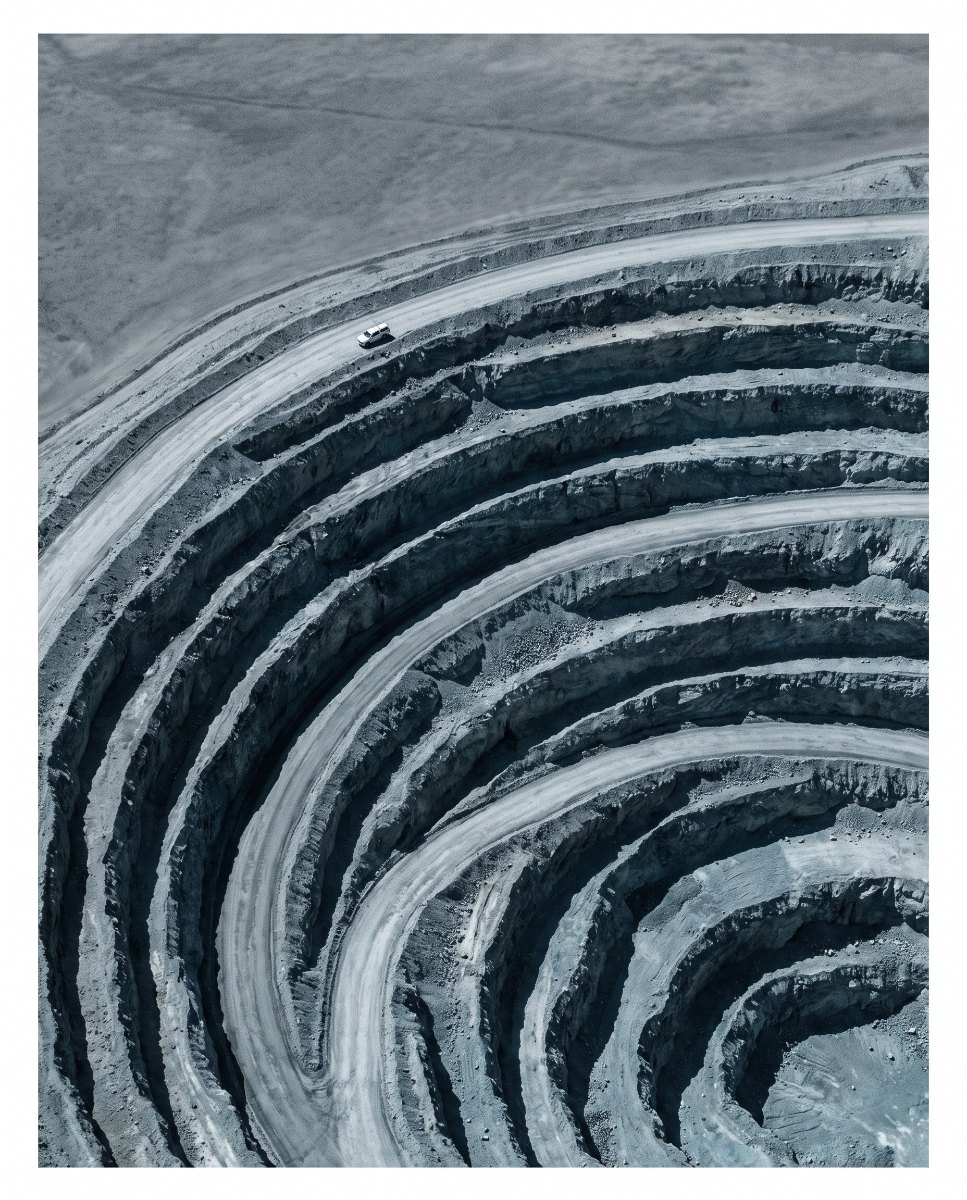Aerial view of a terraced open-pit exploration site